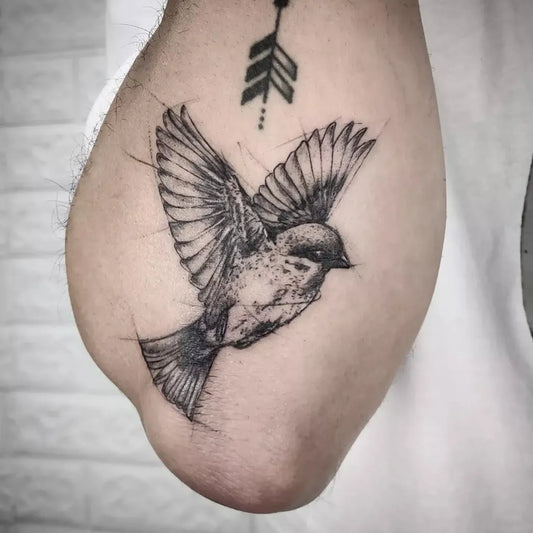 Small Blackwork Sparrow with Arrow Tattoo on Men Arm by @leslau.ink