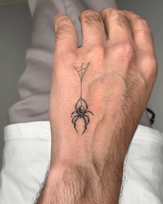 Small Blackwork Spider and Web on Men Hand Tattoo by @tat2noel