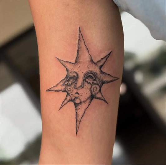 Small Blackwork Star Face Tattoo on Women Arm by @tattoos_by_lace