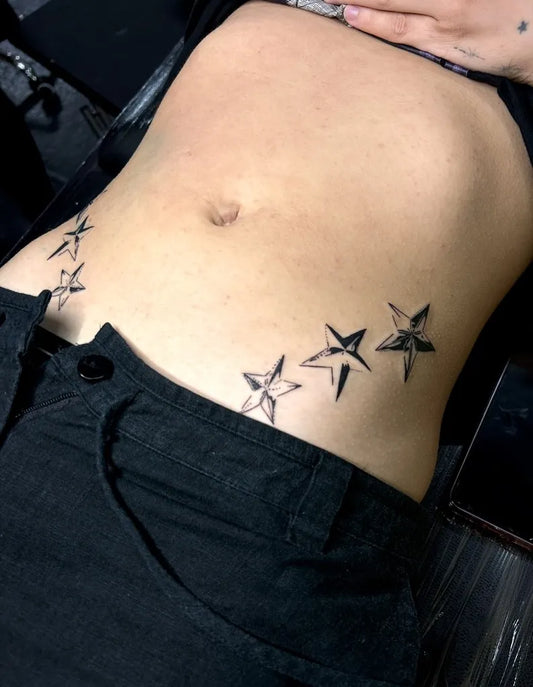 Small Blackwork Star Tattoo on Women Abdomen by @lucydayink