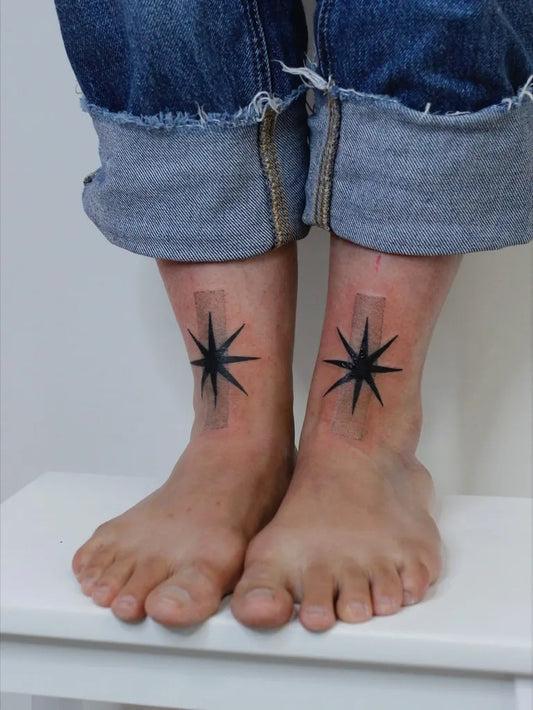 Small Blackwork Star Tattoo on Women Ankles by @nadinerameztattoo