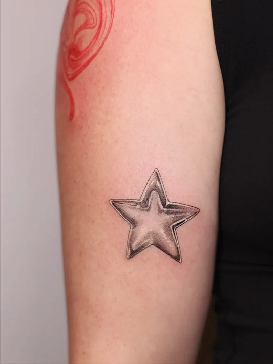Small Blackwork Star Tattoo on Women Arm by @addy.tattoo