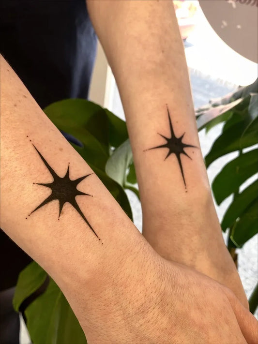 Small Blackwork Star Tattoo on Women Arm by @silly_little_tattooist