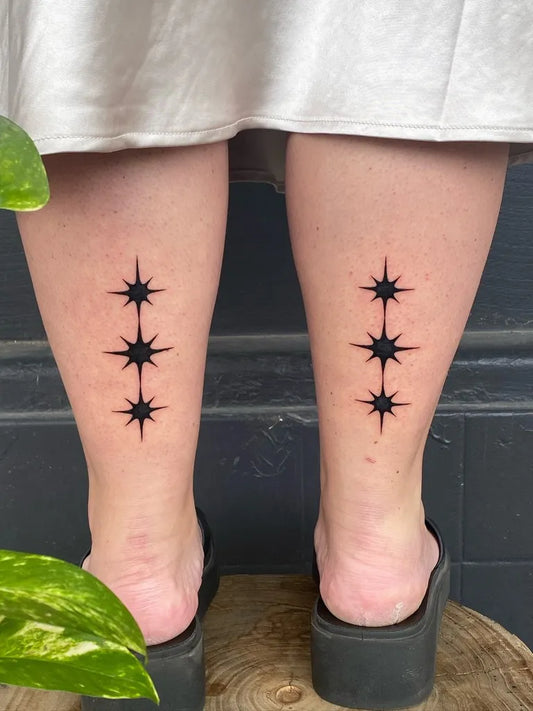 Small Blackwork Star Tattoo on Women Leg by @silly_little_tattooist