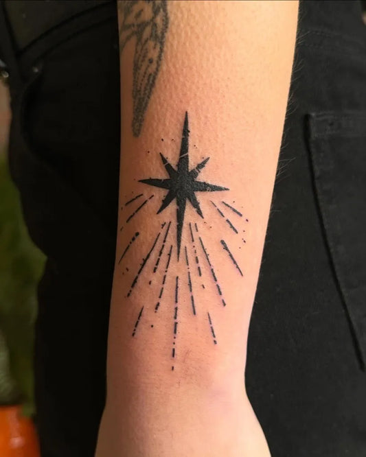 Small Blackwork Star Tattoo on Women Wrist by @fishcake.tats