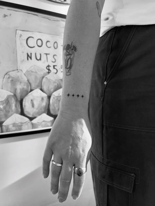 Small Blackwork Star and Coco Nuts Tattoo on Women Arm by @bykaysey