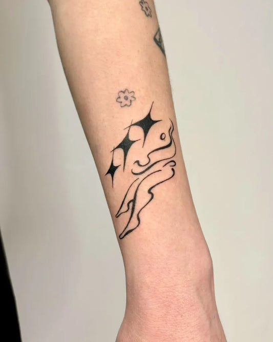 Small Blackwork Star and Rabbit Tattoo on Women Arm by @yas.c.studio