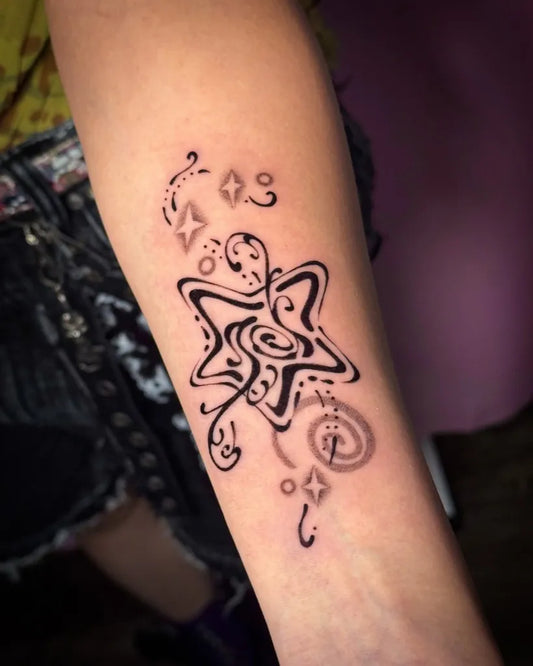 Small Blackwork Star and Swirls Tattoo on Women Arm by @cleanbean.inks