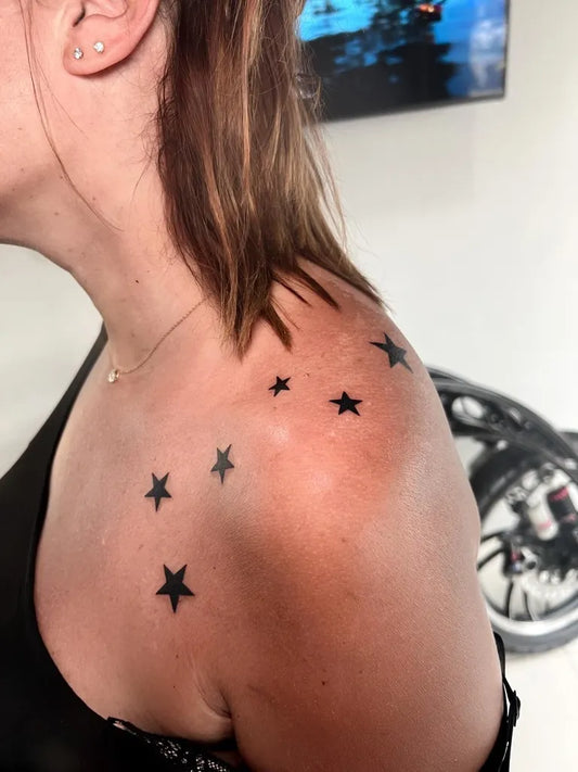 Small Blackwork Stars Tattoo on Women Shoulder by @happyrain.tatt