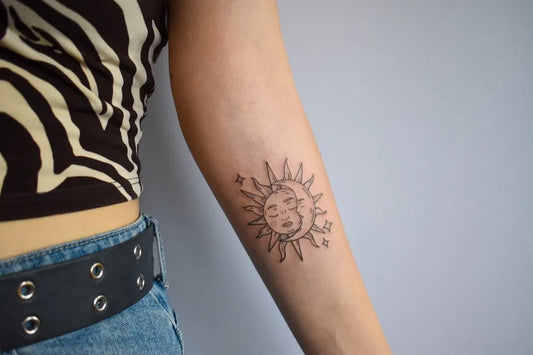 Small Blackwork Sun and Moon on Women Arm Tattoo by @laura.tattooed.this