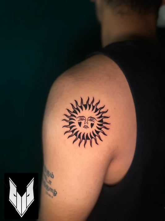 Small Blackwork Sun on Men Shoulder Tattoo by @inkscript.tattoos