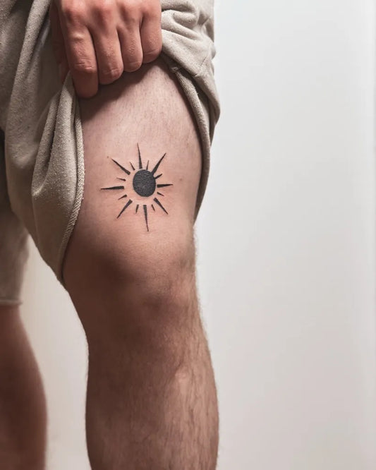 Small Blackwork Sun on Men Thigh Tattoo by @kayyang.tattoo