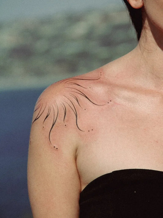 Small Blackwork Sun on Women Shoulder Tattoo by @barnesher_tattoo