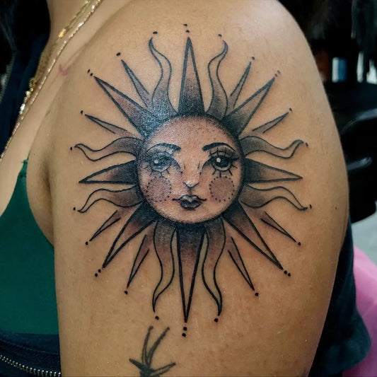 Small Blackwork Sun with Face on Women Shoulder Tattoo by @cholitaunikorn.art