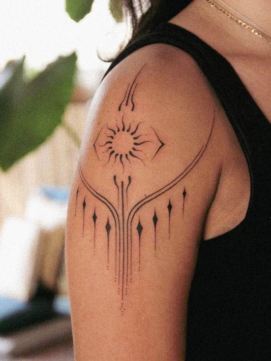 Small Blackwork Sun with Tribal Lines on Women Shoulder Tattoo by @barnesher_tattoo