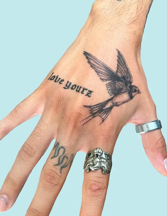 Small Blackwork Swallow Bird on Men Hand Tattoo by @mangopokes