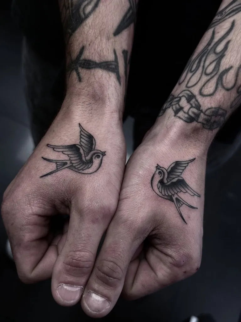 Small Blackwork Swallow Tattoo on Men Wrist by @harryhoy_tattoos