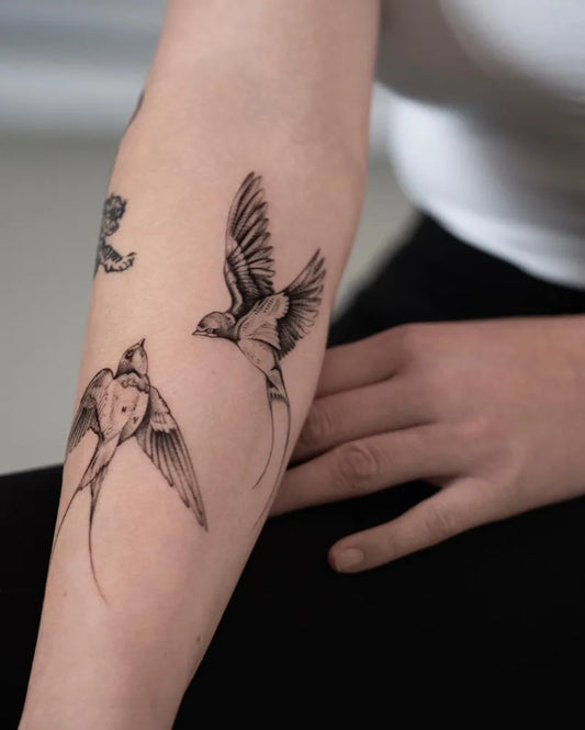 Small Blackwork Swallow Tattoo on Women Arm by @franchesca_tattoo