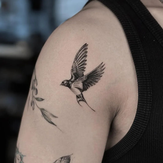 Small Blackwork Swallow and Leaves Tattoo on Men Shoulder by @ajintattoo