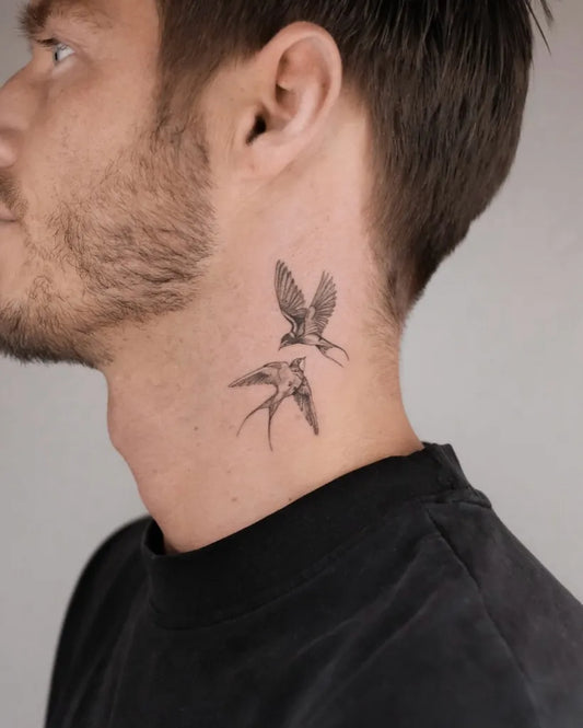 Small Blackwork Swallows Tattoo on Men Neck by @purelines.ink