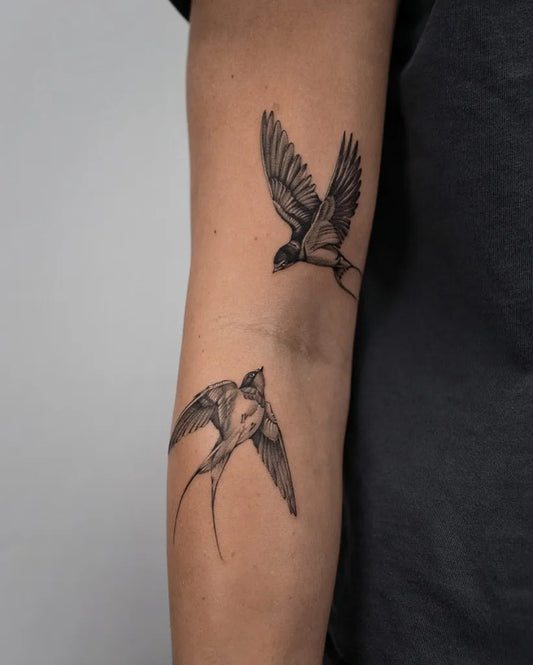 Small Blackwork Swallows Tattoo on Women Arm by @baronart_alan