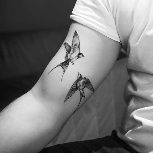 Small Blackwork Swallows Tattoo on Women Arm by @takacs_miklos