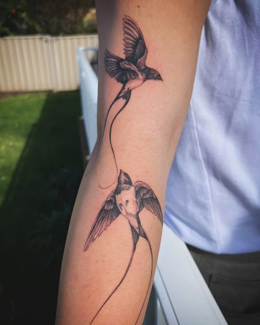 Small Blackwork Swallows Tattoo on Women Arm by @trinity.tatt