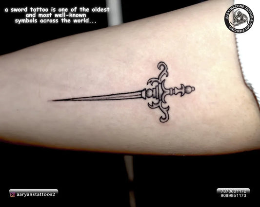 Small Blackwork Sword on Women Arm Tattoo by @aaryanstattoos2