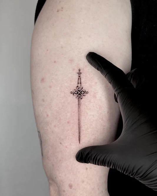 Small Blackwork Sword on Women Arm Tattoo by @osbhui.tattoo