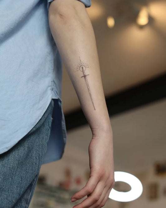 Small Blackwork Sword on Women Arm Tattoo by @skinofglass_