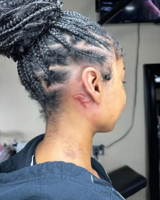 Small Blackwork Symbol Tattoo on Women Behind the Ear by @burnedheartstattoos