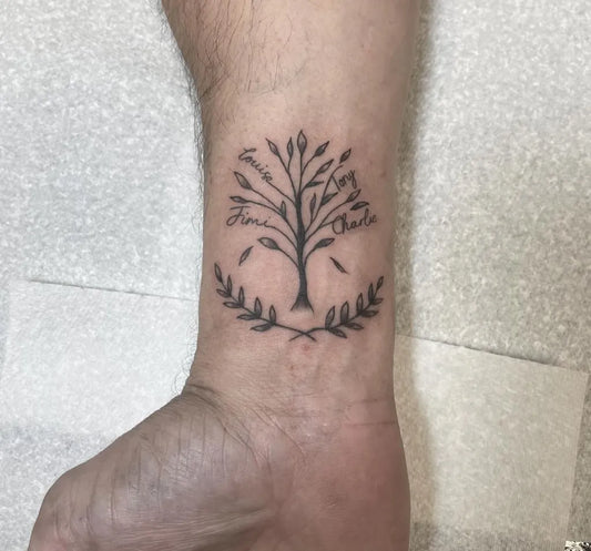Small Blackwork Tree with Laurel Family Tattoo on Men Wrist by @abbiebaldwin.tattoos
