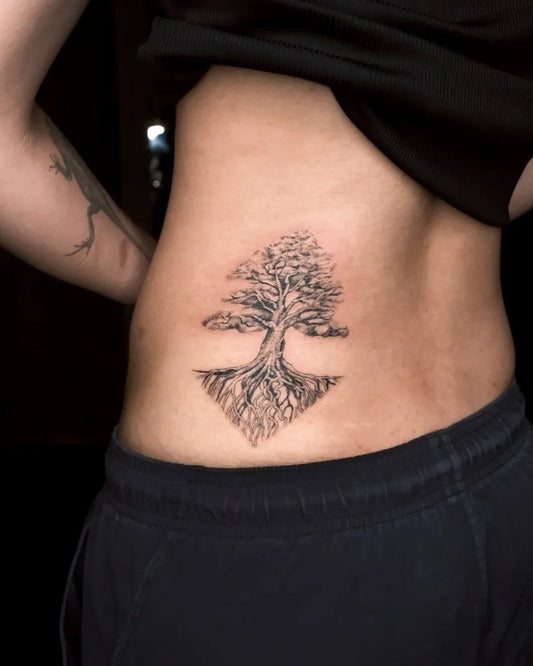 Small Blackwork Tree with Roots Tattoo on Women Flank by @rungch3n