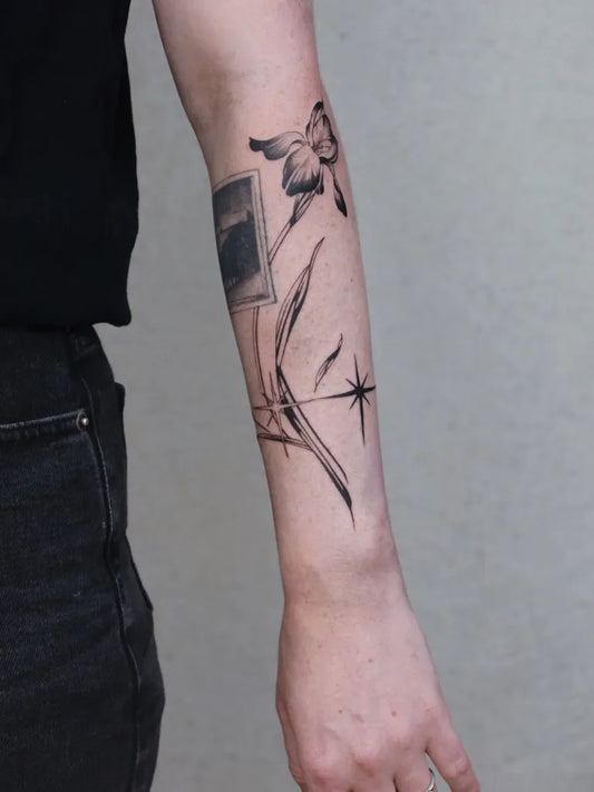Small Blackwork Tulip Star and Polaroid Tattoo on Women Arm by @xinbi.tattoo_