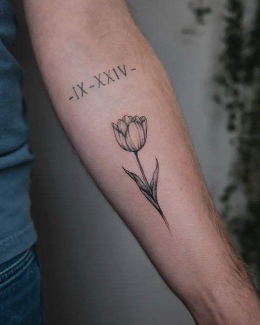 Small Blackwork Tulip and Roman Numerals Tattoo on Men Arm by @dr.kate.tattoo