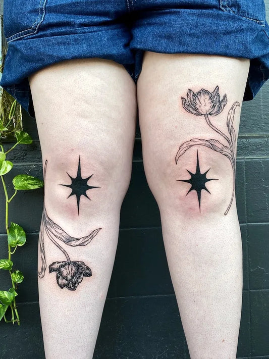 Small Blackwork Tulips and Stars Tattoo on Women Thighs by @silly_little_tattooist