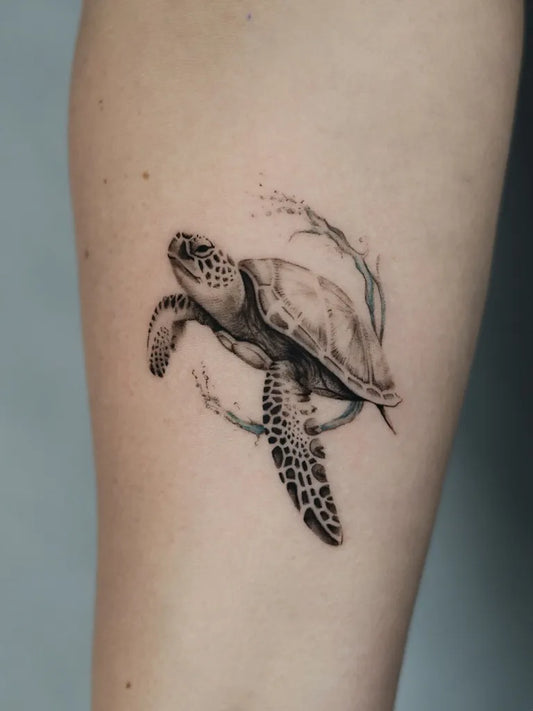 Small Blackwork Turtle Tattoo on Women Arm by @szyna.ink