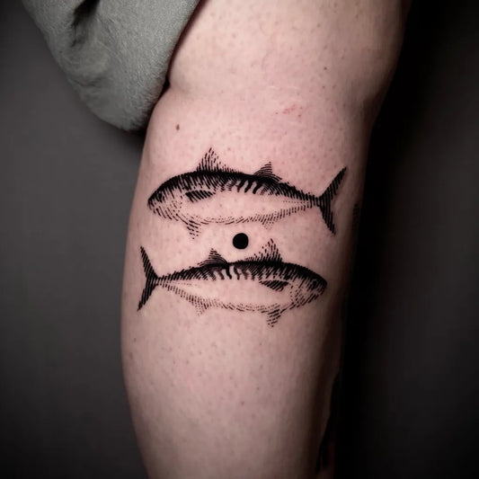 Small Blackwork Two Fish Tattoo on Women Thigh by @tomeshet_tattoo