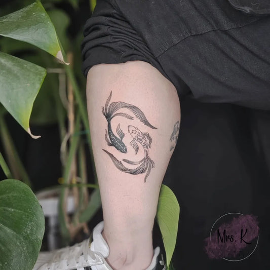 Small Blackwork Two Koi Fish Tattoo on Women Upper Arm by @mrs_k_tatts