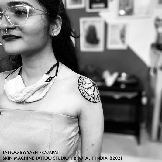 Small Blackwork Vegvisir Tattoo on Women Shoulder by @skinmachinetattoo