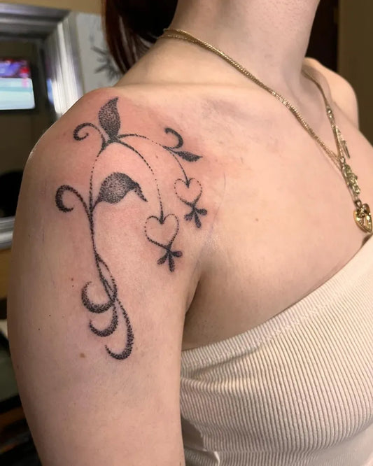Small Blackwork Vine Hearts Leaves Tattoo on Women Shoulder by @tanialeticia.ink