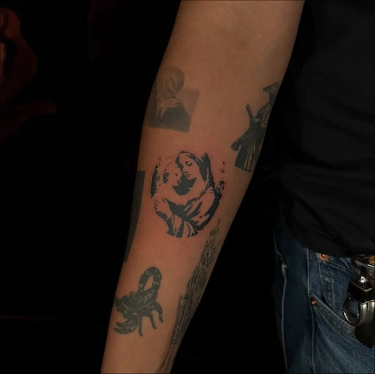 Small Blackwork Virgin Mary and Dog Tattoo on Women Arm by @inkedbylinaa