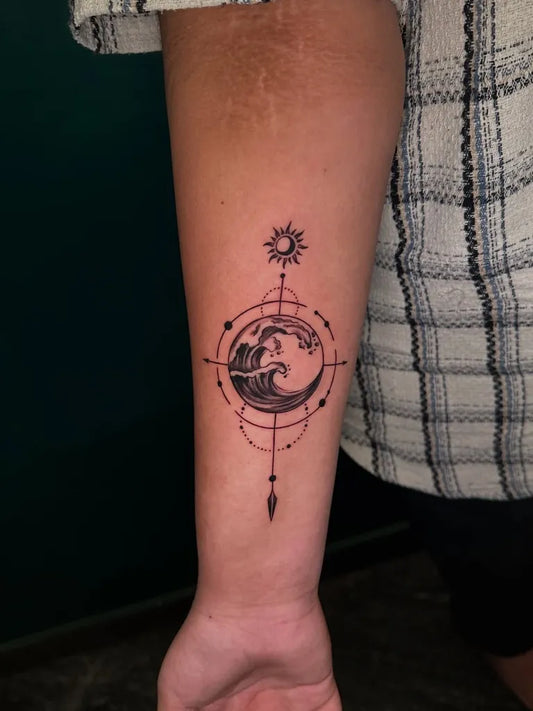 Small Blackwork Wave Compass Tattoo on Women Forearm by @inkscript.tattoos