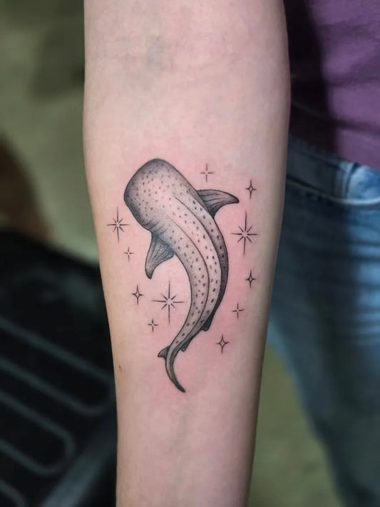 Small Blackwork Whale Shark with Stars on Women Arm Tattoo by @tattoop.art