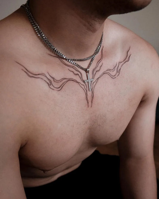 Small Blackwork Wings and Cross on Men Chest Tattoo by @anna.tattoo.w
