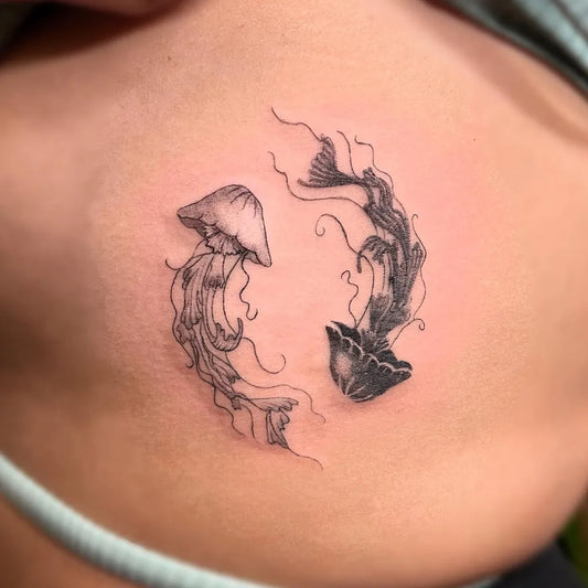 Small Blackwork Yin Yang Jellyfish Tattoo on Women Back by @sophie_a_tattoo