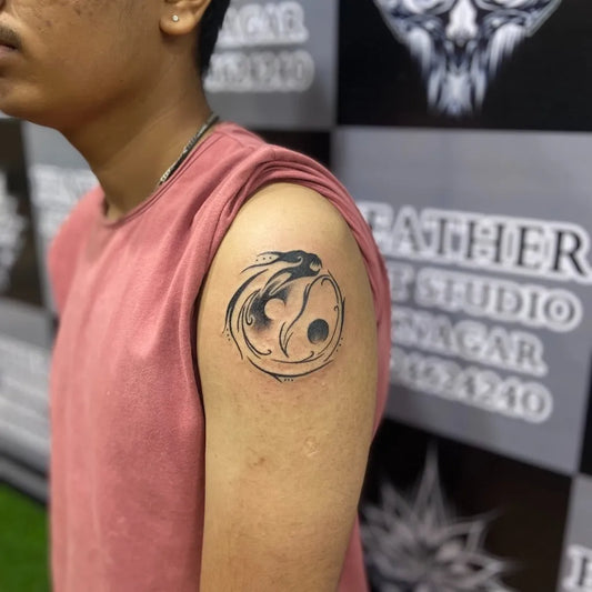 Small Blackwork Yin Yang Koi Tattoo on Men Arm by @feather_art_studio_