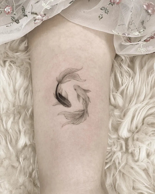Small Blackwork Yin Yang Koi Tattoo on Women Thigh by @tattoobychang