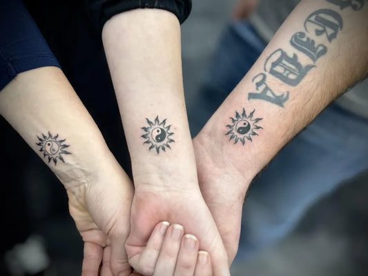 Small Blackwork Yin Yang Sun Flowers Tattoo on Women Wrists by @vilma_tattoo