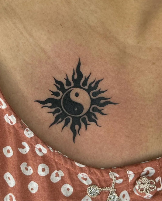 Small Blackwork Yin Yang Sun Tattoo on Women Chest by @skytattoos111